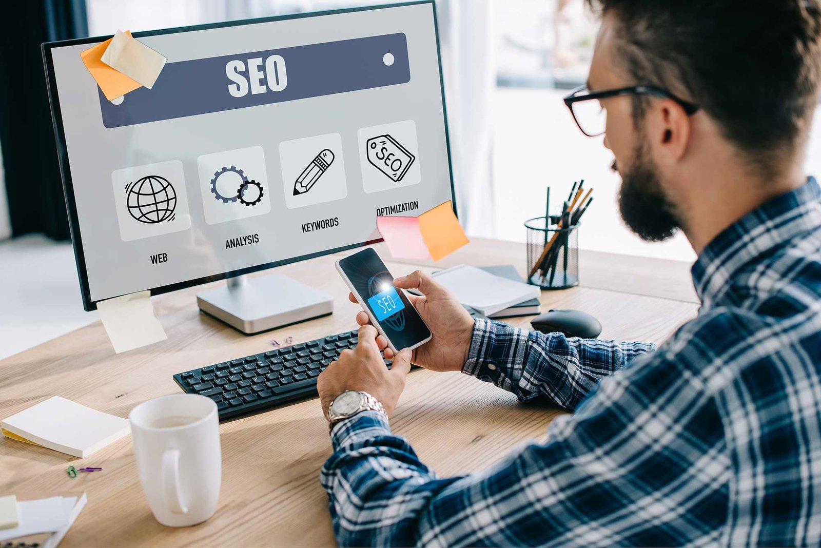 handsome young seo manager using smartphone and co 2023 11 27 04 50 44 utc 1